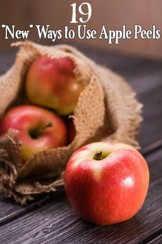 two apples sitting next to each other on top of a wooden table with burlocks