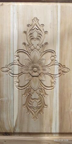 an intricately carved wooden door with wood paneling