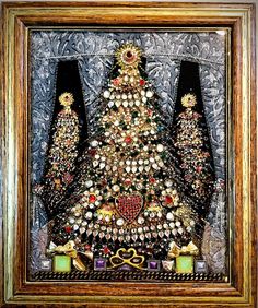 a christmas tree made out of buttons and other items in a wooden frame on the wall