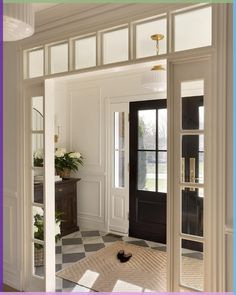 an open door leading into a room with black and white checkered flooring