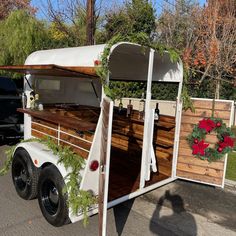 a food truck is decorated with flowers and greenery on it's side for the holiday season