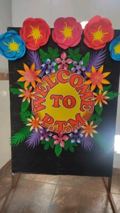 a sign that says welcome to the nation with flowers and leaves on it in front of a tiled floor