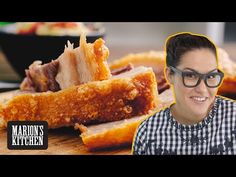 a woman with glasses sitting in front of some food