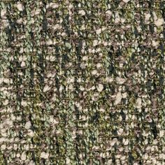 an up close shot of a green and white tweed fabric