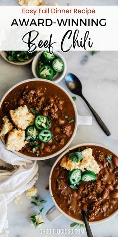 two bowls filled with beef chili and topped with croutons