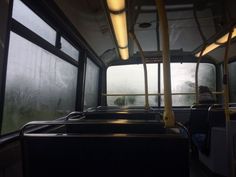 the inside of a bus with lots of windows and no people on it in the dark