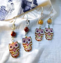 "Adorn your ears with these delightful silver owl earrings featuring your choice of red/burgundy or yellow/ochre mookite beads. The charming owl charms showcase a printed design with a protective resin coating, while the back boasts a textured silver finish. The handmade earring hooks crafted from sterling silver wire add a touch of sophistication. Lightweight and colorful, these owl earrings are versatile, complementing both casual and dressy ensembles. Embrace the spirit of fall and winter wit Earrings Bird, Woodland Earrings, Multi Gemstone Necklace, Woodland Jewelry, Crystal Heart Necklace, Winter Jewelry, Owl Earrings, Crystal Jewelry Sets, Silver Owl