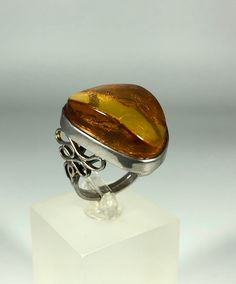 Discover the timeless elegance of our Spectacular Orange-Brown Amber Ring, expertly crafted for ladies in stunning 925 sterling silver. This exquisite piece features natural Baltic Sea amber, renowned for its unique beauty and healing properties. Perfect for any occasion, this amber ring will add a touch of sophistication to your jewelry collection. Product Details: Material: 925 Sterling Silver Stone: Natural Baltic Sea Amber Color: Spectacular Orange-Brown Design: Minimalist Style Ring Size: 8 Luxury Amber Rings For Formal Occasions, Sterling Silver Open Ring For Formal Occasions, Shiny Finish Open Ring Jewelry, Unique Formal Rings With Polished Finish, Formal Open Ring Jewelry With Shiny Finish, White Gold Rings With Shiny Finish For Gift, Formal Open Ring With Shiny Finish, Luxury Silver Cabochon Ring, Elegant Amber Jewelry With Polished Finish