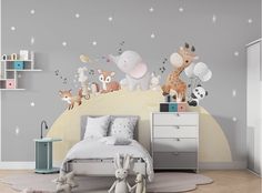 a child's bedroom with an elephant and giraffe mural on the wall