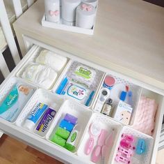 an organized drawer with toothbrushes, soaps and other items