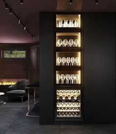 a wine cabinet filled with lots of bottles and glasses