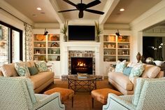 a living room with couches, chairs and a fire place in the fireplace area