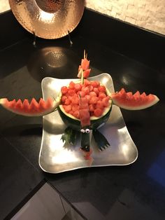 a plate with watermelon and other food on it