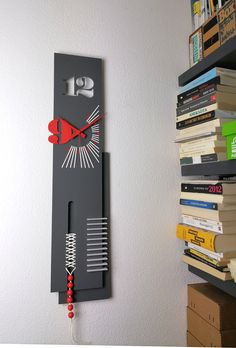 a clock that is on the side of a wall next to some books and boxes