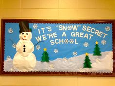 a bulletin board with a snowman and trees on it that says, it's snow secret we're a great school