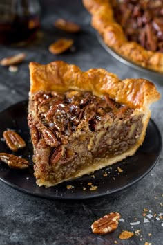 a slice of pecan pie on a black plate