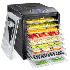 an electric food dehydrator with trays full of fruits and veggies