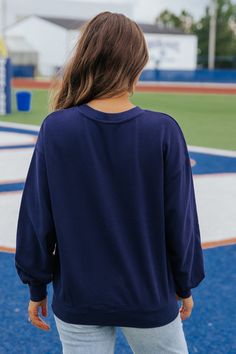 This game day sweatshirt is an essential for game days and everyday wear! Stay warm and stylish in our Navy Game day Graphic Sweatshirt! Made with 100% soft cotton, this long sleeve sweatshirt features a round neckline and ribbed cuffs for a comfortable fit. Simply style it with your favorite denim wear and sneakers to complete the look! Bright Colors Fashion, Game Day Sweatshirt, Shopping Games, Gameday Dress, Denim Wear, Casual White Dress, Power Dressing, Game Dresses, Influencers Fashion