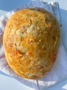 a round bread sitting on top of a white napkin