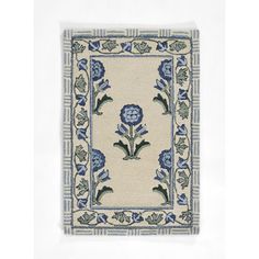 a blue and white rug with flowers on it