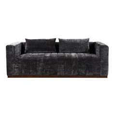 a black couch with four pillows on the back and one arm folded up to it's side