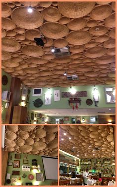 the inside of a restaurant with baskets hanging from the ceiling and pictures on the walls