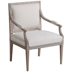 an antique style chair with white upholstered fabric