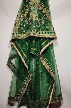 Absolute one of a kind, hand crafted green beaded net shawl. This shawl is a show stopper! Take notice of the heavily embroidered border and beaded centre, that would adorn any bride it is placed upon. We absolutely stand by our products and will be here to support you along your whole shopping journey. You can also find us on Instagram @AfghanWeddingThingss Feel free to send any inquiries about any of our products. Embellished Green Dupatta For Festivals, Green Dupatta Shawl For Wedding, Green Dupatta With Handwork For Party, Festive Green Lehenga With Handwork, Green Lehenga With Zari Work For Festival, Traditional Green Shawl For Festive Occasions, Traditional Green Lehenga With Handwork, Traditional Embellished Lehenga For Festival, Green Festival Lehenga With Zari Work