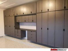 an empty garage with lots of cabinets and drawers