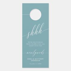 a blue door hanger with the word shhl on it and a white circle