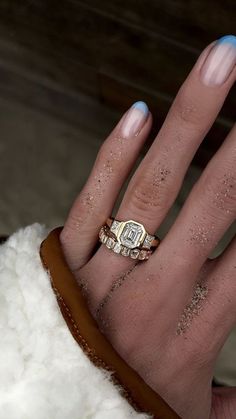 a woman's hand with two rings on it and one ring in the middle