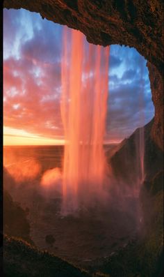 an image of a waterfall in the middle of the ocean at sunset or sunrise time