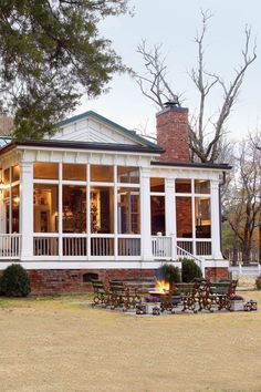 a large white house sitting on top of a lush green field