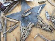 a star made out of driftwood and wood shavings on a wooden table