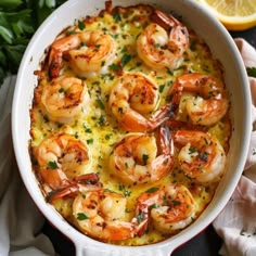 a casserole dish with shrimp and cheese in it, garnished with parsley