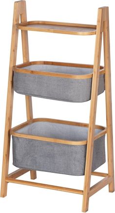 a wooden shelf with two grey baskets on the bottom and one gray basket below it