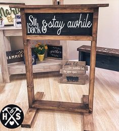 a wooden sign sitting on top of a hard wood floor