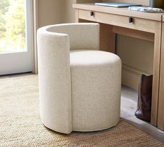 a white chair sitting in front of a wooden desk