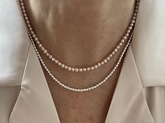 "This classic necklace is made from high quality genuine AAA grade 4.5mm semi-round round pink all natural fine freshwater pearls with peach undertones, with a high luster. A delicate, feminine & classy necklace perfect for all occasions and bridal too. These pearls have a rich luster, are perfectly calibrated, and are uniform in size.  Pearls have an international grading scale, these beautiful pearls are graded as follows: surface: AAA luster: AAA round: AA+ - Photos taken outside in natural lighting and in a light box.  - No filters or color enhancements are added to the photos.  The pearls are strung on strong 21 micro woven stainless steel beading wire with nylon coating. I use only the finest brightly polished sterling silver and gold filled  findings. A large clasp that is easy to h Elegant Pink Necklaces For Everyday, Elegant Pink Necklace For Everyday Wear, Elegant Pink Necklace For Everyday, Elegant Pink Necklace With Tiny Beads, Elegant Rose Gold Necklaces With Tiny Beads, Elegant Necklace With Tiny Round Beads, Elegant Everyday Pearl Necklace With Tiny Beads, Elegant Round Necklace With Tiny Beads, Delicate Pink Pearl Necklace With Pearl Chain