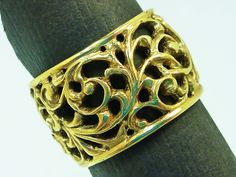 This intricate solid 14 karat filigree ring is 12 millimeters wide all the way around.  The intricate scrolls were all hand tooled using ancient goldsmithing techniques.  This ring is available in up to a size 6 for this listed price.  Please inquire for sizing price options. Ornate Gold Engraved Ring With Filigree, Ornate Gold Engraved Filigree Ring, Ornate Gold Filigree Engraved Ring, Gold Jewelry With Intricate Design And Wide Band, Ornate Gold Engraved Ring With Intricate Design, Ornate Yellow Gold Filigree Ring With Intricate Design, Elegant Wide Band Filigree Ring With Intricate Design, Traditional Gold Engraved Filigree Ring, Traditional Engraved Gold Filigree Ring