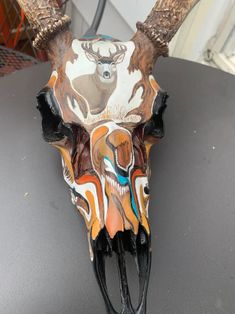 an animal's skull with antlers painted on it