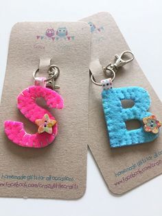 two keychains made to look like the letters b and c are decorated with felt