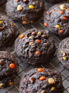 chocolate chip cookies with candy corn and chocolate chips are cooling on a wire rack, ready to be eaten