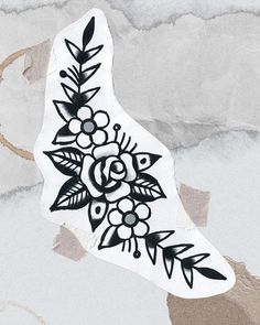 a piece of paper with black and white flowers on it