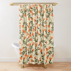 an orange and green floral shower curtain hanging on a white wall next to a bathtub