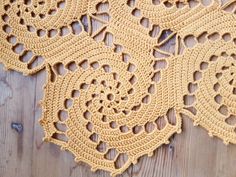 crocheted doily on wooden surface with wood flooring in the foreground