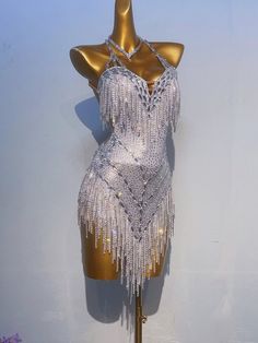 a mannequin dressed in silver with fringes on it