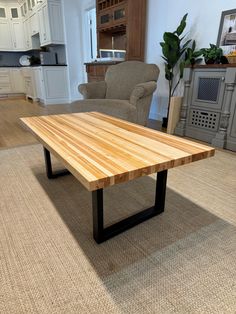 a wooden table sitting in the middle of a living room