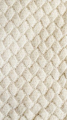 the texture of an upholstered blanket is shown in white and beige colors, as well as some other patterns