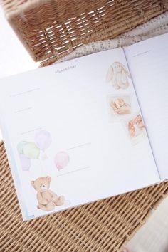 an open book with pictures of teddy bears and balloons on the pages, sitting next to a wicker basket